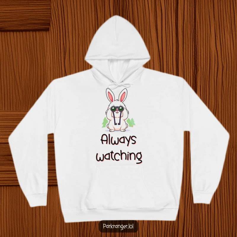 Funny hoodie featuring a cheerful, fluffy rabbit character using binoculars to gaze at distant trees, perfect for cozy exploration.