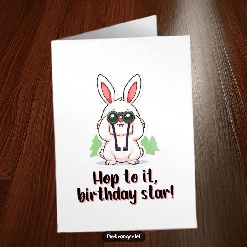 Cheerful Free Printable Birthday Card featuring a fluffy rabbit with binoculars looking at distant trees, sending birthday wishes.