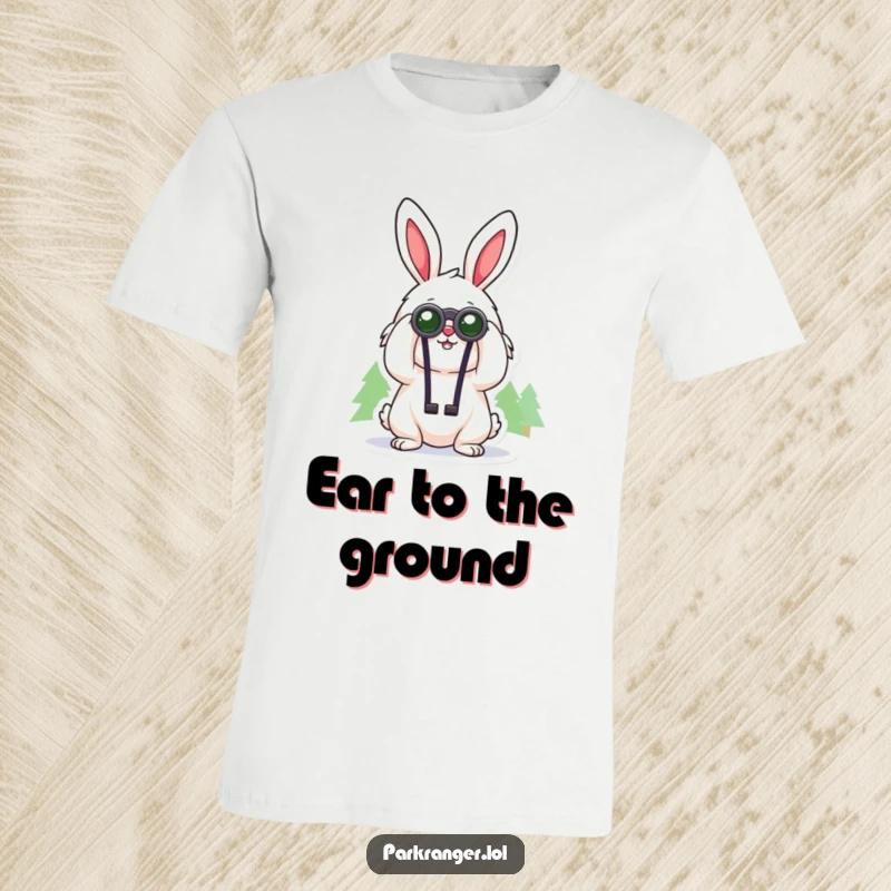 Funny t-shirt depicting a cheerful, fluffy rabbit character using binoculars to look at distant trees, a curious nature observer.